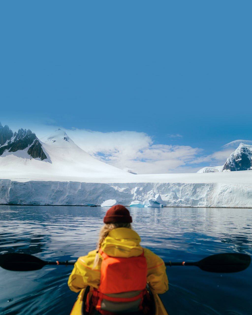 Kayaking beside a glacier